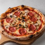 pizza-with-mushrooms-olives-is-cutting-board (1)